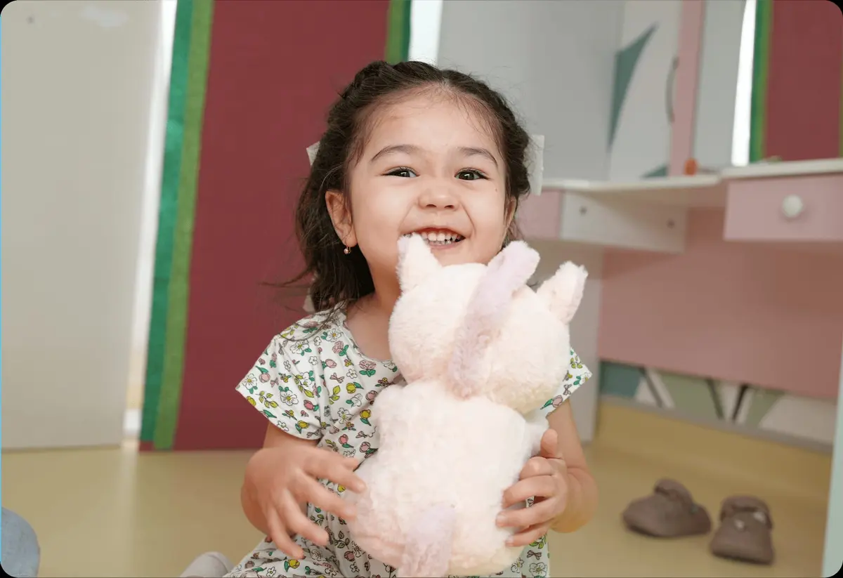 Child with plush toy